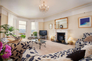 The spacious, light-filled lounge with gorgeous views across the River Teign in Salty House
