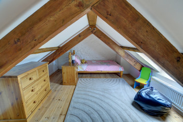 Galleried single bedroom with sloping ceilings, suitable for a child