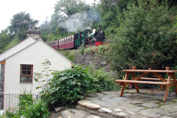 There is a steeply terraced garden and patio area to the side of the cottage, with picnic bench, and views of the steam trains running immediately behind the cottage on the Ffestiniog Railway