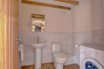 Downstairs Cloakroom with toilet and waching machine.