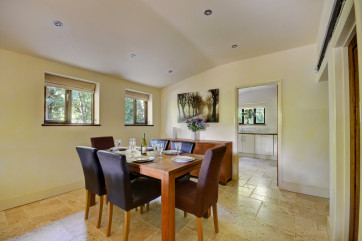 The dining room has an attractive dining table with six chairs and leads through to the kitchen