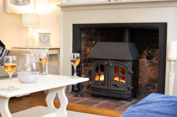 Cosy in front of the wood burner in the sitting room, the perfect spot to enjoy a glass of wine after a day of exploring