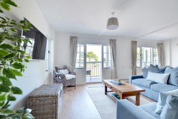 Harbour View has a very spacious and comfortable open plan living area with two French windows leading out onto a full length canopied balcony