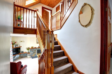 The staircase form the sitting room, leading up to the first floor with hand banisters