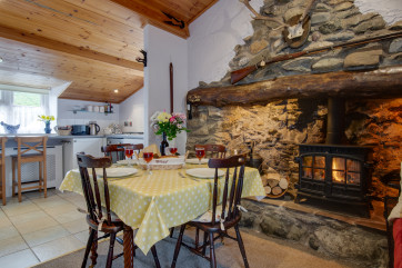 open plan kitchen diner with extra seating and lovely wood burning stove