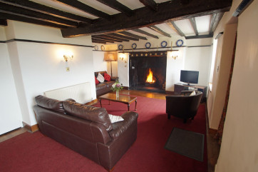 Beautiful, beamed living room with an impressive inglenook fireplace
