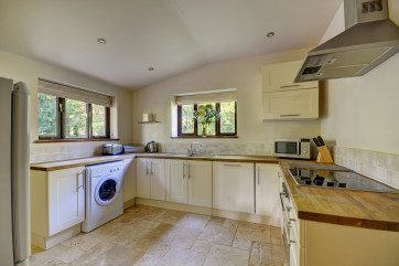 The built in cooker has a stainless steel cooker hood with extractor over, the window looks out to the garden