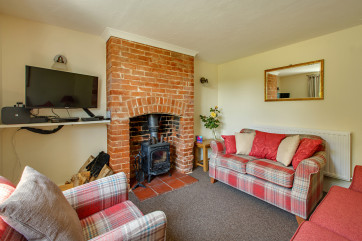 Cosy Sitting Room with comfortable seating, wood burner and TV