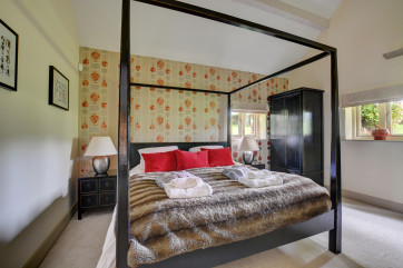 Master bedroom with a king size four poster bed, Smart TV