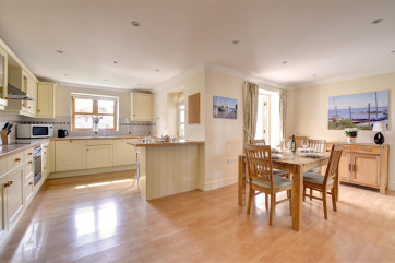 Kitchen and dining area with table set for four