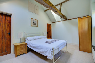Bedroom one is light and bright with a velux window and a double bed