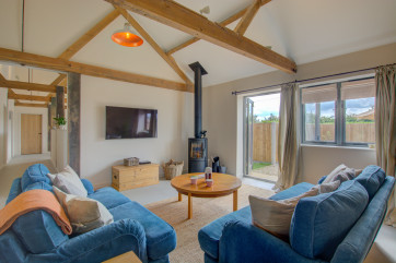 Sitting Room with comfortable seating, tv, woodburner & coffee table