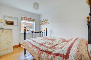 Compact but bright double bedroom with wrought iron double bed