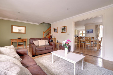 Sitting room with comfy chairs looking into dining area