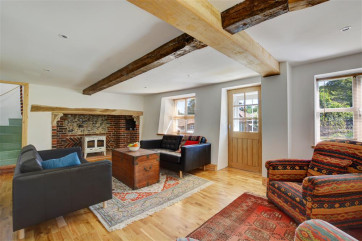 Comfy seating and rustic beams in the sitting room