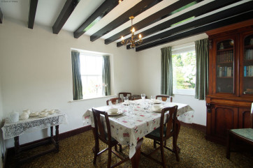 Separate dining room enjoying views over the garden towards the sea