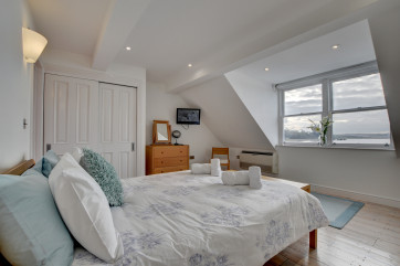 The master bedroom is on the top floor and has stunning sea views