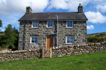 This lovely stone former farmhouse stands in a secluded location on the slopes below Cadair Idris