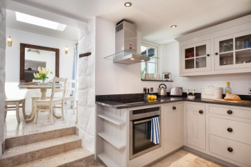 Spacious cottage kitchen with 3 steps to the elegant breakfast room.