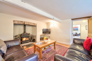 Cosy sitting room with log burner