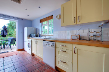 The kitchen is fully fitted with shaker style cream units and a good range of appliances