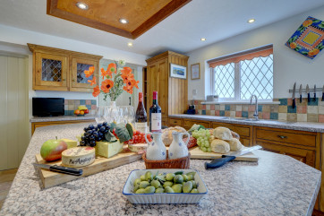The large kitchen is extremely well equipped and has plenty of space for preparing family meals