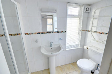 Fully tiled, modern En-suite with shower cubicle.