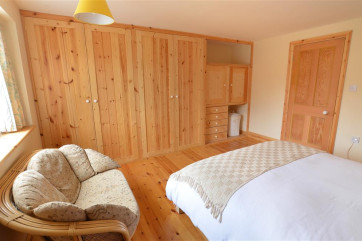 Another view of bedroom 1 with seating and ample storage
