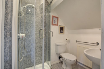 The en suite shower room with cubicle 