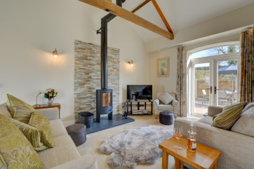 Spacious sitting room with log burner 