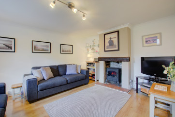 Cosy Sitting Room with comfortable furnishings, woodburner and TV