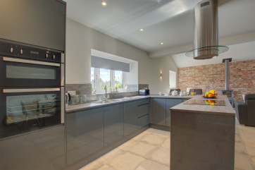 Open Plan Kitchen/Living Room with fitted units, built in oven, island with hob & extractor fan