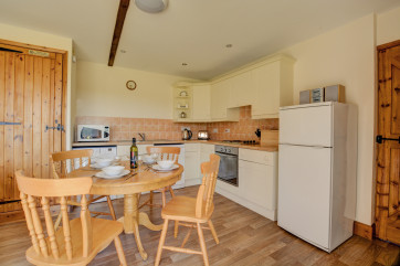 Kitchen area with fitted units & table table & chairs