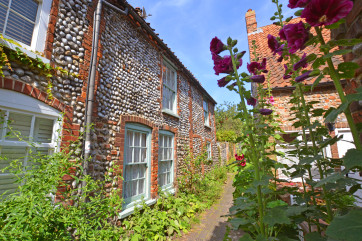 Hollyhock Cottage, built by traditional Norfolk brick and flint