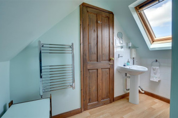 Shower room showing towel rail and hand basin