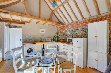 The kitchen is a lovely rustic room with electric oven and hob