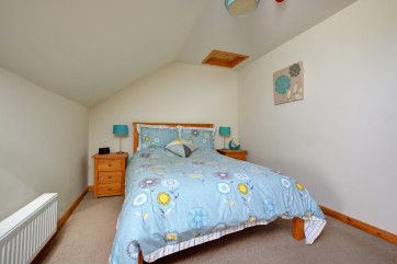 Pretty double bedroom with a double bed and sloped ceilings
