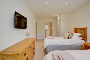 Bedroom 3 with twin beds and wall mounted TV