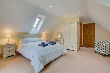 Another spacious bedroom with sloping ceiling and a good range of cream furniture for all your belongings.