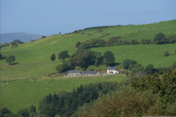 Two 5 star holiday cottages and the owners's farmhouse in a lovely setting. Photo by Storm Development