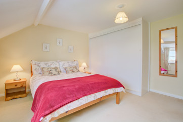 Nicely furnished double bedroom with a double bed and built-in storage