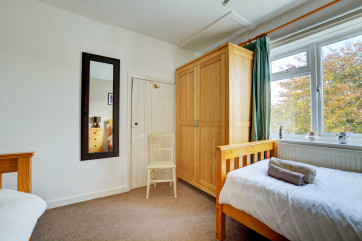 The twin bedroom has seating and storage 