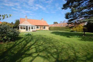 A lovely property set in a large lawned garden.