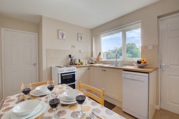 A compact kitchen overlooking the south facing garden.