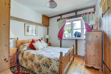 Lovely cottage style double bedroom with a double bed and pine furniture