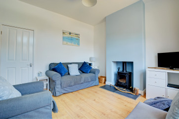 Sitting room with comfortable seating, woodburner and TV