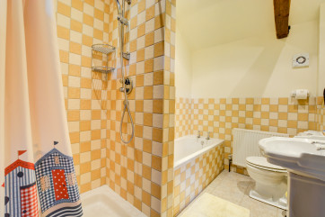 A modern bathroom with a bath and shower