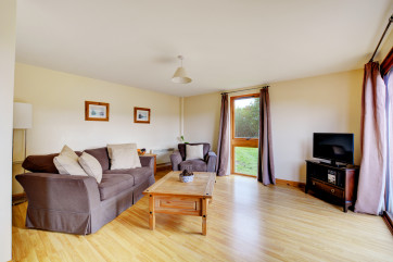 The spacious sitting room is comfortably furnished.