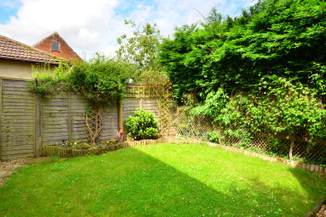 Fully enclosed with lawn and patio area with table and chairs, perfect for al fresco dining
