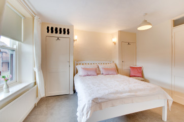 A lovely double bedroom with a small cloakroom off with washbasin and wc.